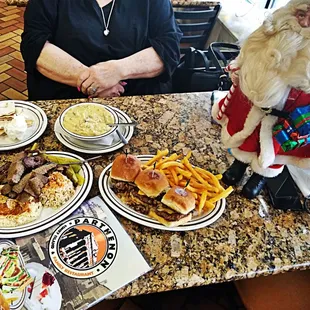 a woman sitting at a table with plates of food