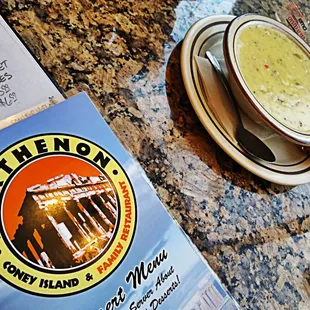 a bowl of soup and a menu