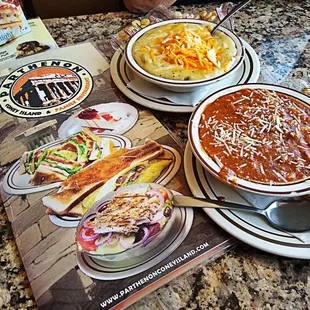 two bowls of chili soup and a packet of chips