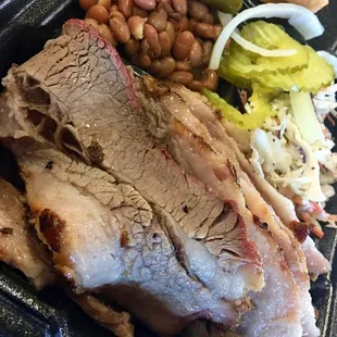 pork, beans, pickles, and a sandwich