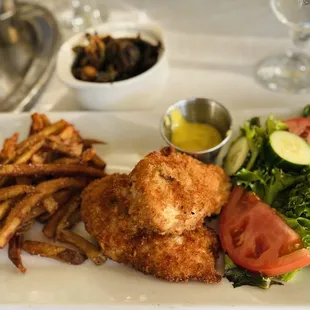 a plate of french fries and a salad