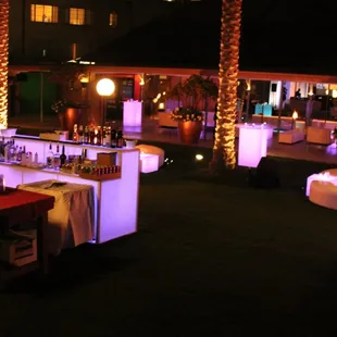 Customized LED logo tables and leather furniture for corporate event.