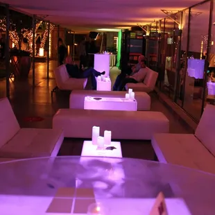 Customized LED logo tables and leather furniture for corporate event.