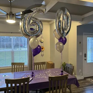 Confetti and streamers and purple tablecloth and great balloon bouquets for the 60th birthday girl!! She loves it!!