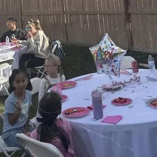 Tables with white linen covers and chairs