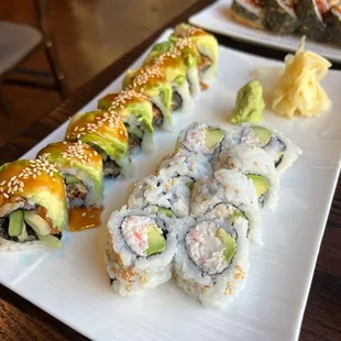 various types of sushi on a white plate
