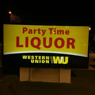 a neon sign in a parking lot