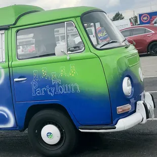 a green and blue vw bus
