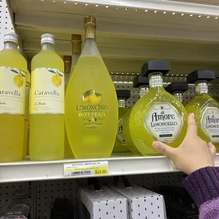 a person reaching for a bottle of lemonade