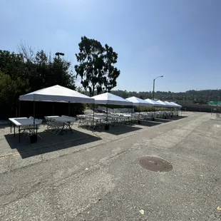 10x10 white EZ Ups, 8 foot banquet tables, standard white chairs
