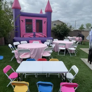 Pink/purple 13x13 bounce house, 60 inch round tables, standard white chairs, light pink linen, kids tables/chairs
