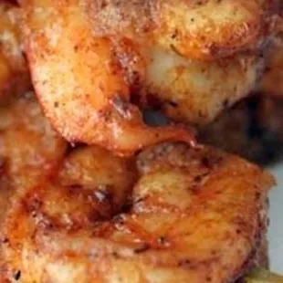 a close up of a plate of grilled shrimp