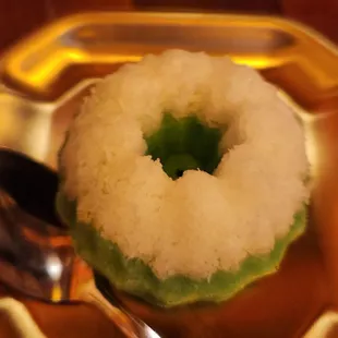 a plate with a donut and a spoon
