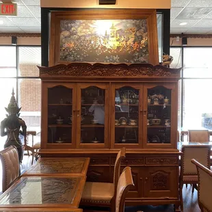 Notice carvings on table top, displays in cabinet &amp; painting.