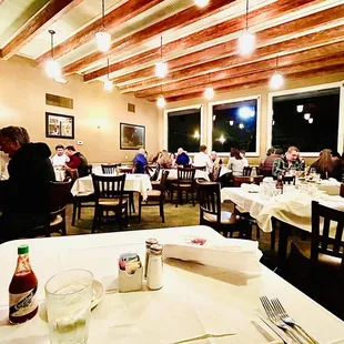 a group of people sitting at tables in a restaurant