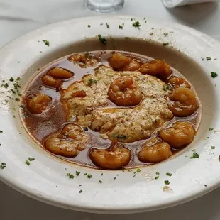 a bowl of stew and a plate of shrimp