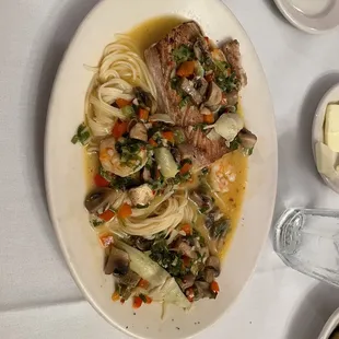 Grilled Fish Orleans - Mahi-mahi with shrimp and artichokes over angel hair pasta with a Cajun fish stock sauce!  Yummy!