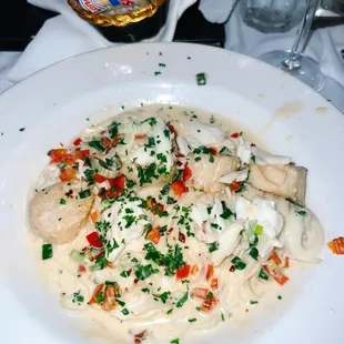 Crabmeat &amp; Scallops Sautéed in olive oil, green onions, and red peppers with a cream sauce served over pasta