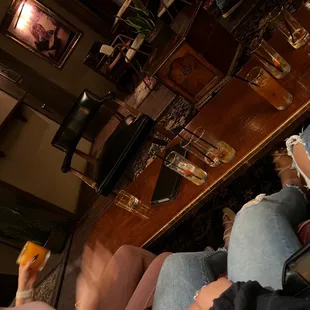 a person sitting on a couch eating a piece of pizza