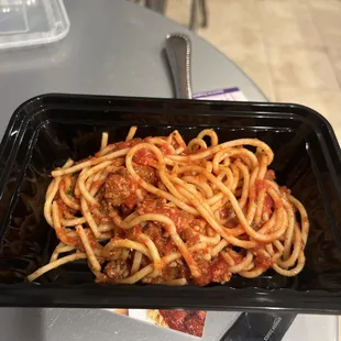 a plate of spaghetti and meat