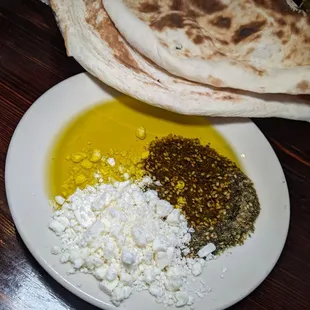 Bread served with oil, zataar, and feta