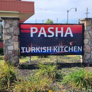 a sign in front of a restaurant