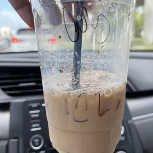 a hand holding a cup of coffee