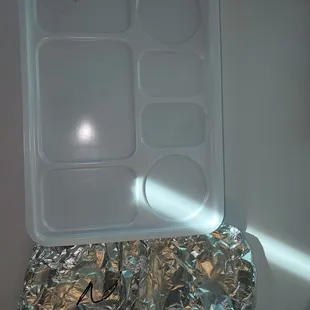 Sealed platter box with side naan bread in foil