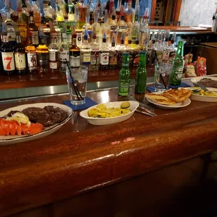 a variety of food on a bar