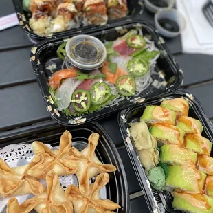 three trays of food on a picnic table