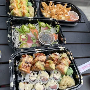 three trays of sushi with different toppings