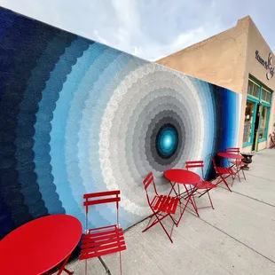 a mural of a circular design on the side of a building