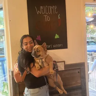 a woman holding a dog in her arms