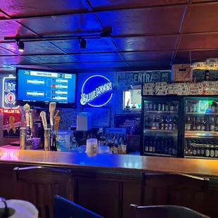 a bar with neon signs