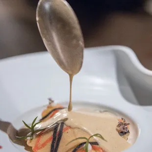 Ravioli: dungeness crab, black garlic, peanut, finger lime