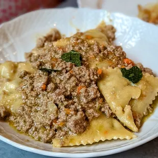 a plate of pasta with meat and vegetables