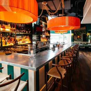 a restaurant with a bar and chairs