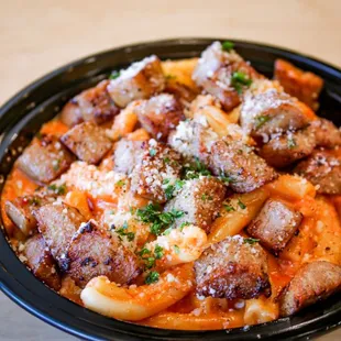 a bowl of pasta with meat and cheese