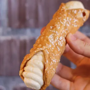 a hand holding a pastry