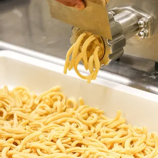 a pasta being made in a machine