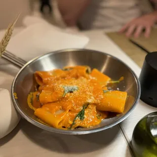 a bowl of pasta and a glass of wine