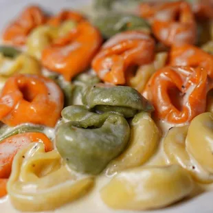 a plate of pasta with shrimp and vegetables