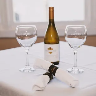 a bottle of wine and two wine glasses