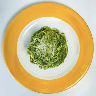 a plate of pasta with pesto sauce