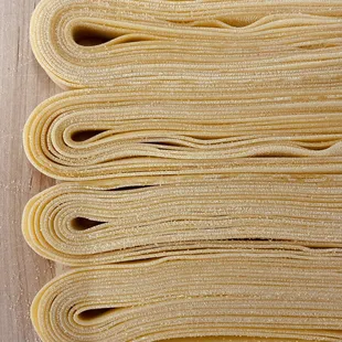 a stack of uncooked rolled up pasta