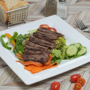 Mista con Manzo: 
mixed greens salad with a grilled  NY strip slices on top, in a balsamic and EVOO dressing.