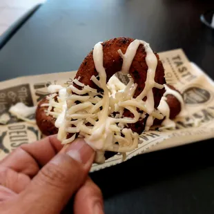 Venezuelan Pretzel (Mandocas) is deep-fried plantain dough with cheese on top.