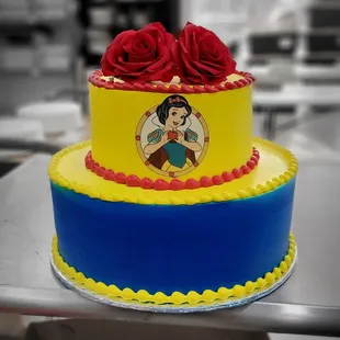 a snow white cake with red roses