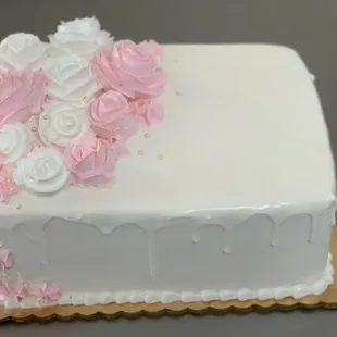 a white cake with pink and white flowers