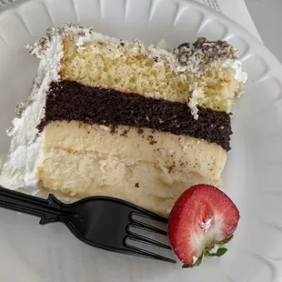 Slice of 4 layer cake. Top-Bottom: tres leches, chocolate, flan, cheesecake